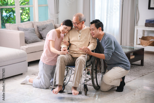 Asian family person health care and insurance at home concept, man and daughter woman take care support to senior elderly father patient in wheelchair together, having smile in happy love lifestyle