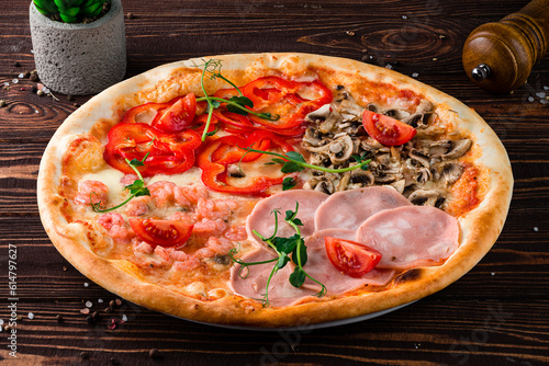 Pizza with ham, shrimp, mushrooms, cheese, sweet peppers, tomatoes and microgreens, junk food.