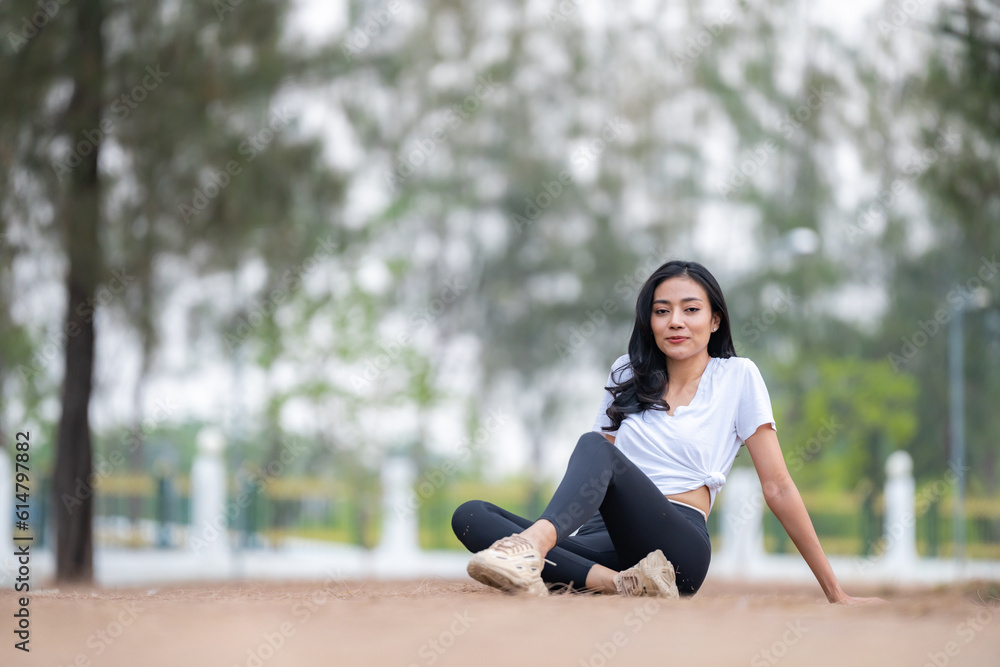 Fitness Asian woman doing yoga in park and jogging at city park in summer morning. Healthy female athlete enjoy outdoor sport training workout exercise and running, Healthy and happy women concept.