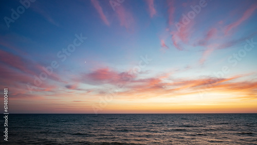 Sunset on the sea in the clouds with sun rays