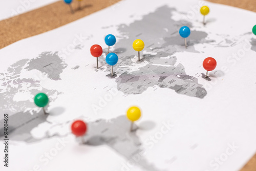 Close up of Pushpins on world map on Corkboard. Travel destination concept
