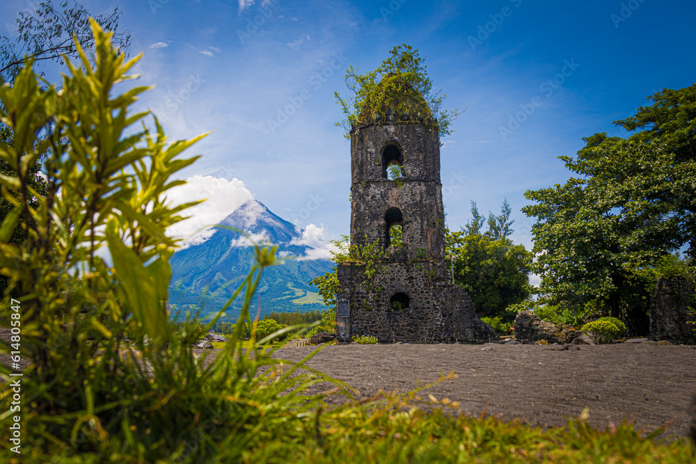 volcano in eruption next to old bell tower demolished by lava - obrazy, fototapety, plakaty 