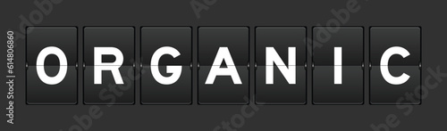 Black color analog flip board with word organic on gray background