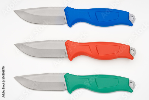 Knives with colored handles against a white background.