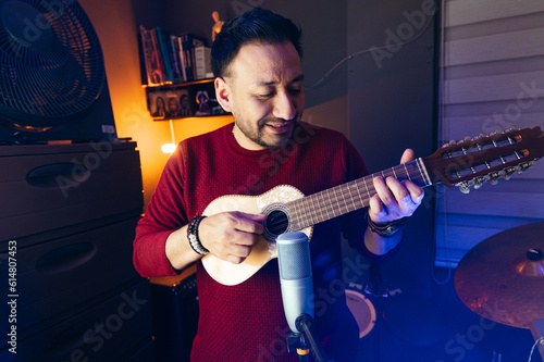 man playing charango in the studio photo