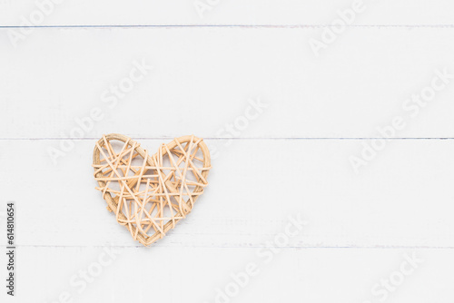 Wooden wicker heart on whit...
