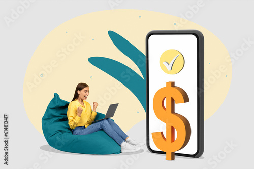 Successful online transaction. Excited young woman looking at laptop  sitting near huge smartphone with dollar icon