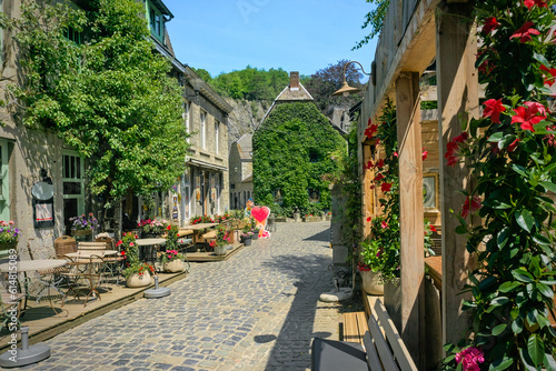 A narrow cobblestone street in Durbuy, the smallest city in Belgium, surrounded by historical stone houses.