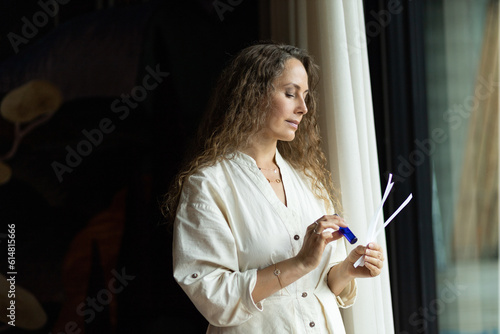 Girl perfumer chooses a fragrance on blotters, portrait. The concept of aromatherapy and perfumes made of aromatic oils photo