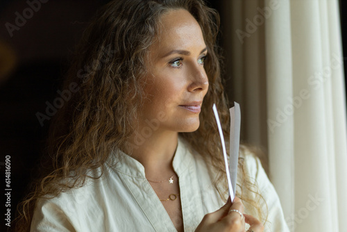 Girl perfumer chooses a fragrance on blotters, portrait. The concept of aromatherapy and perfumes made of aromatic oils