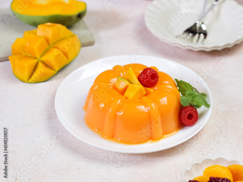 Mango pudding, jelly, dessert on white plate. Close up. photo