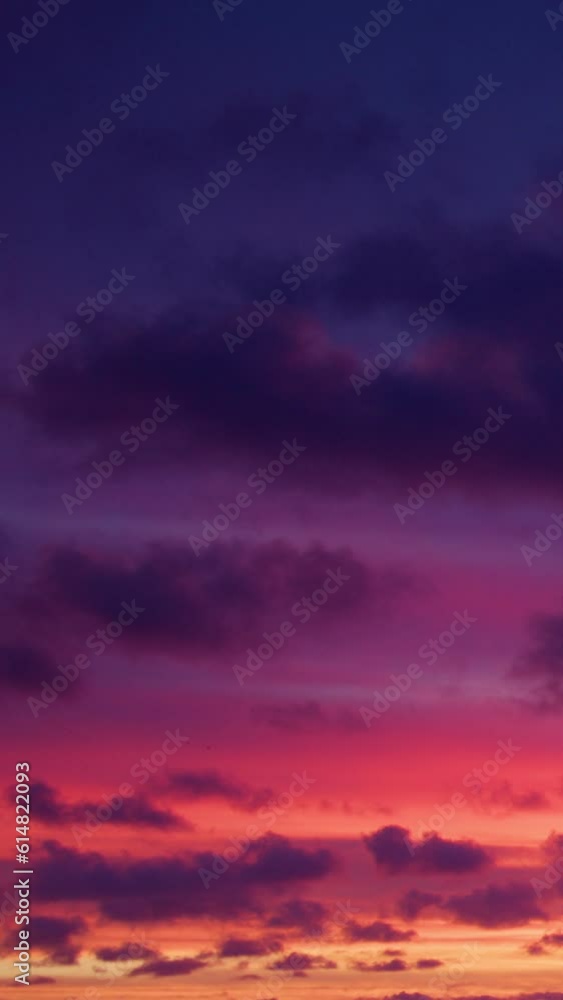 The clouds were illuminated with the warm glow of pink at dawn, offering a magnificent view to start the day. Vertical video. The clouds were illuminated with the warm glow of pink at dawn, offering a magnificent view to start the day. Vertical video.