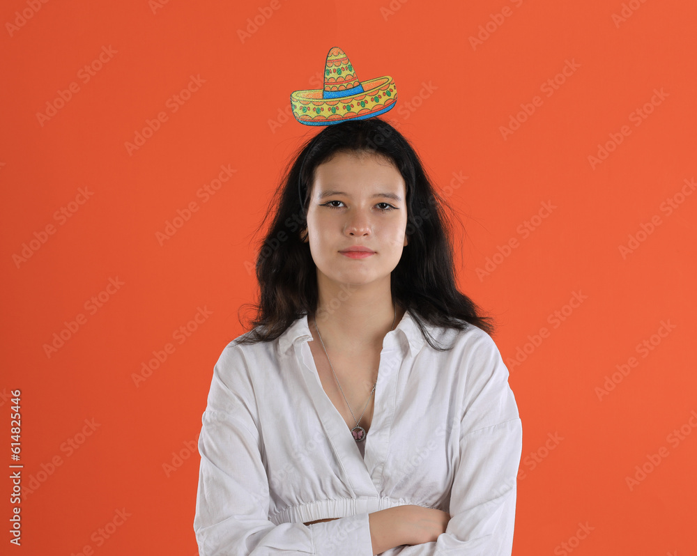 girl with mexican headband on orange background girl with mexican headband on orange background