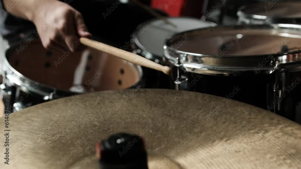 Man hands playing on drums and bronze cymbal plates with drumsticks live. Musician during percussion musical instrument perfomance closeup Man hands playing on drums and bronze cymbal plates with drumsticks live. Musician during percussion musical instrument perfomance closeup