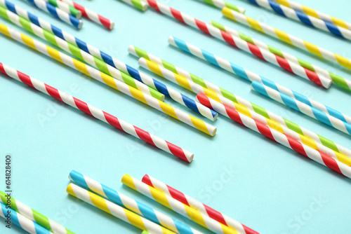 Different paper drinking straws on blue background