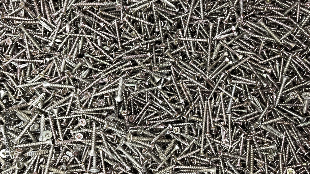 Black long screws close-up in a box. screws for assembling furniture or screwing anything, construction tools, bolts and accessories, sharp screws made of durable steel Black long screws close-up in a box. screws for assembling furniture or screwing anything, construction tools, bolts and accessories, sharp screws made of durable steel