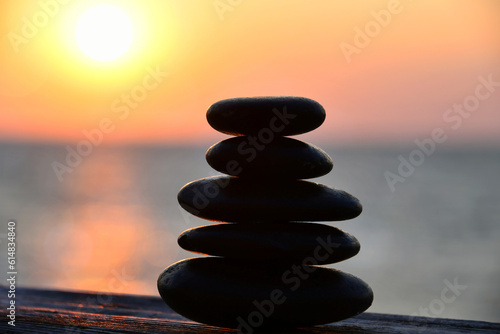 Relaxation Zen concept - cairn  stacked stones outside  blurred sunset sun nature background