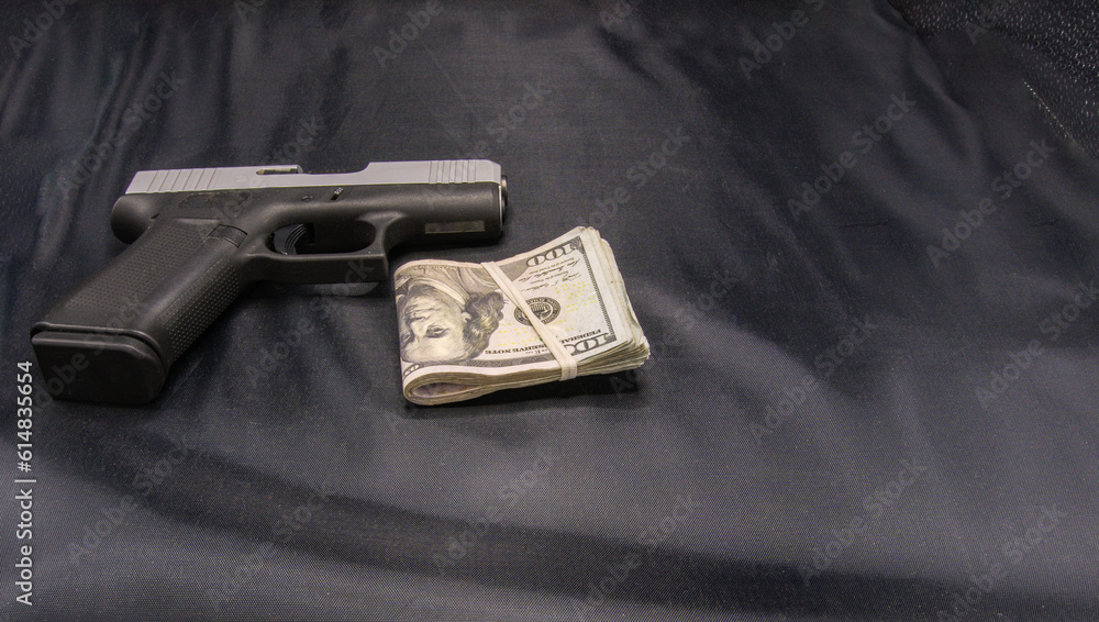 Gun and money on black background Gun and money on black background