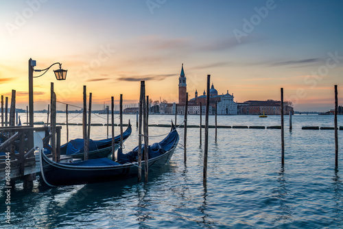 View of San Giorgio Maggiore Island with gondolas from San Marco square in Venice at sunrise, Italy, Europe.