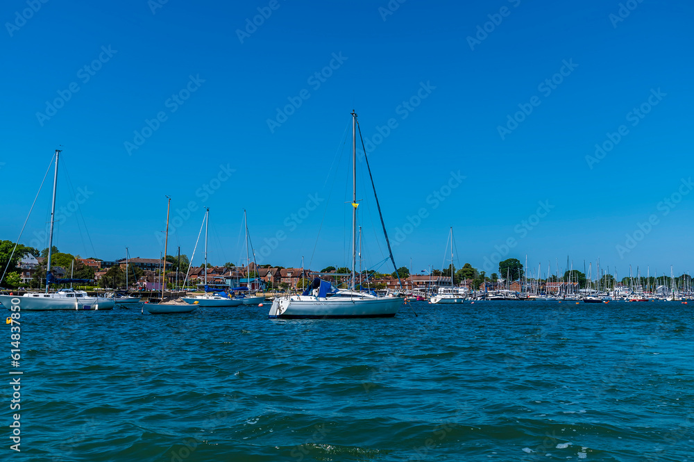 A view of sail boats moored on the River Hamble, Hampshire in summertime