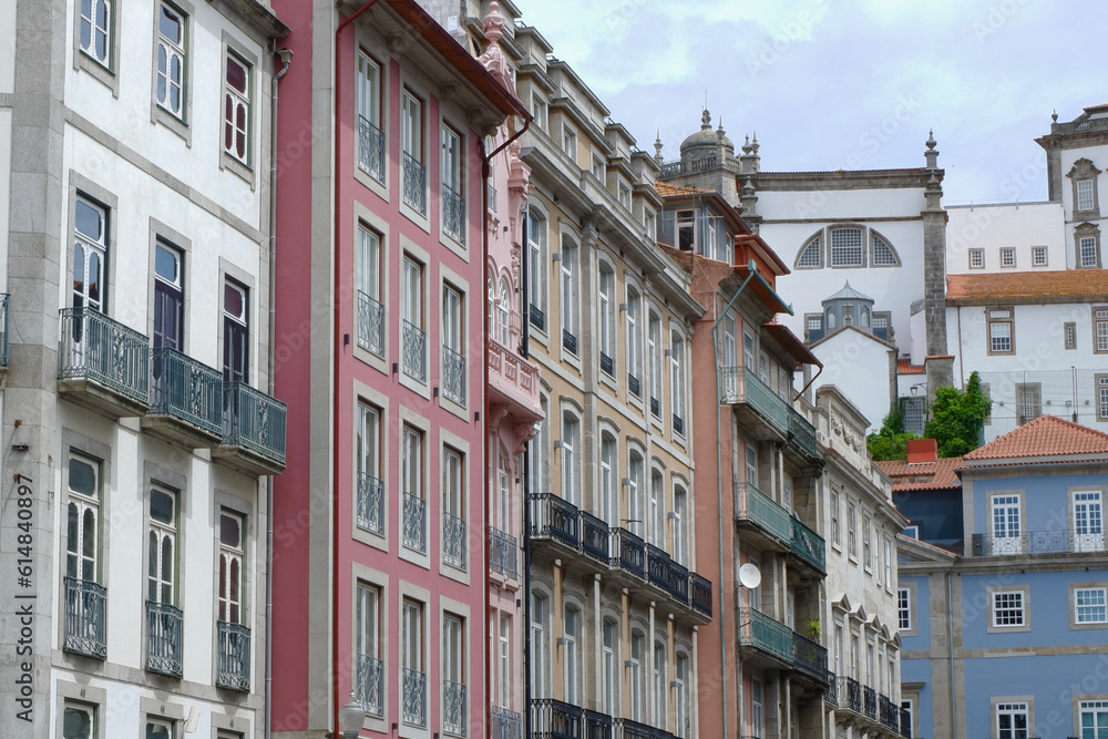 Traditional historic facades painted in different colours downtown in Porto, Portugal. Vintage architecture. Old fashioned living