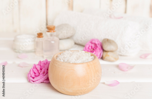 Spa composition with pink roses on wooden table