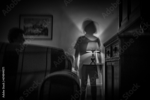 ghost in a hotel room 
in black and white photo