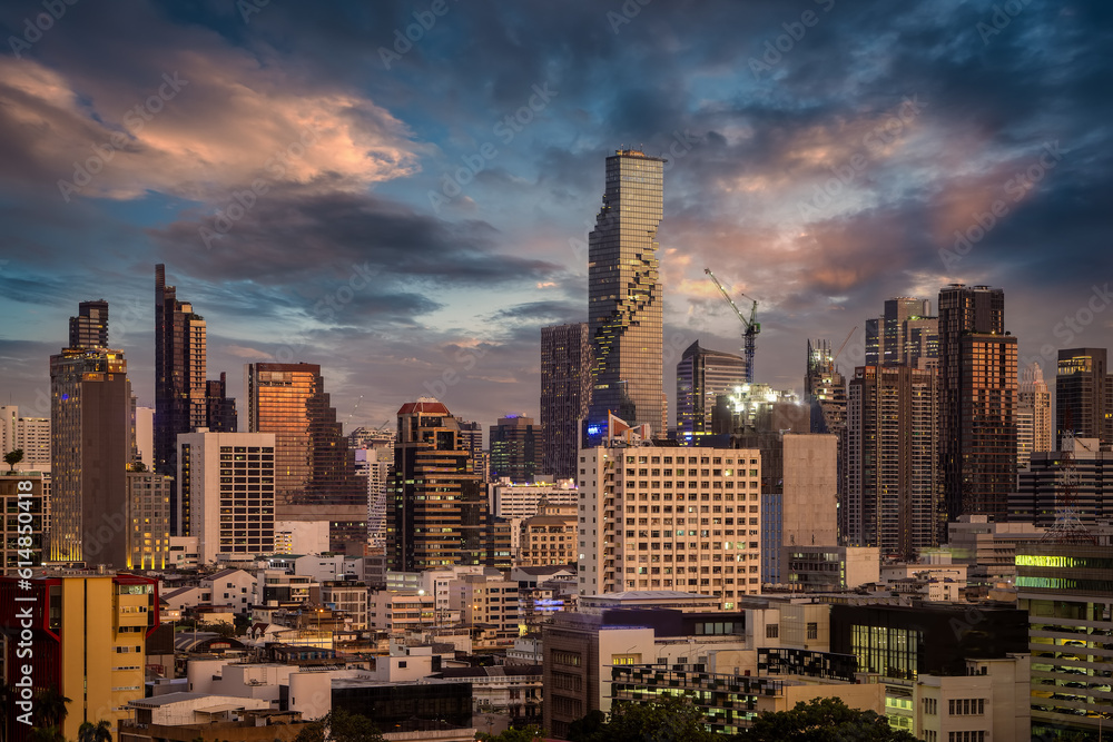 Fototapeta premium The urban skyline of the city center of Bangkok, Thailand, with the modern skyscrapers during sunset time