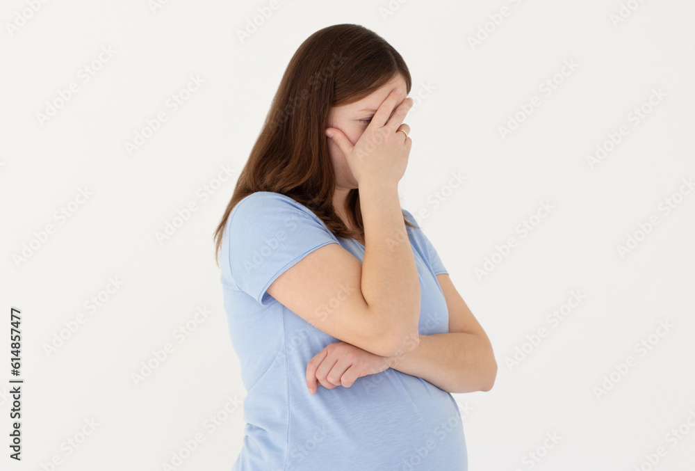 Embarrassed annoyed adult pregnant woman hiding face bend head down, facepalm, smirk irritated, not looking friend acting weird, feel humiliated uncomfortable, standing white background Embarrassed annoyed adult pregnant woman hiding face bend head down, facepalm, smirk irritated, not looking friend acting weird, feel humiliated uncomfortable, standing white background