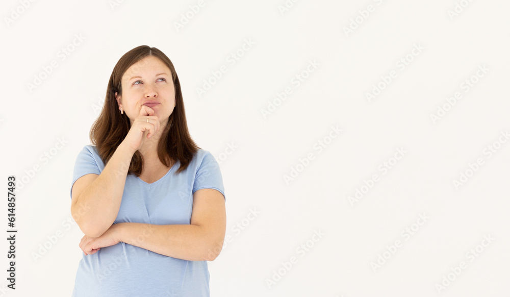 Portrait of standing with thoughtful serious smart expression, pondering answer, having doubts and suspicion, wearing blue T-shirt pregnant woman. Indoor studio shot isolated on white background. Portrait of standing with thoughtful serious smart expression, pondering answer, having doubts and suspicion, wearing blue T-shirt pregnant woman. Indoor studio shot isolated on white background.