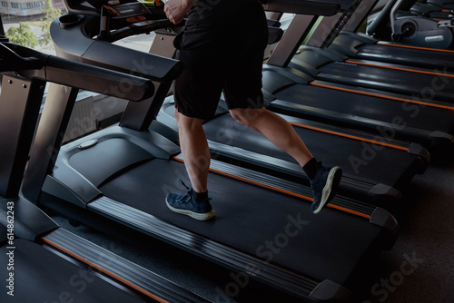 Athlete legs running on the track in the gym