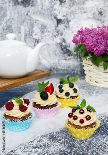 A delectable cupcake adorned with a vibrant assortment of fresh fruits. The moist cake base perfectly complements the burst of fruity flavors. 