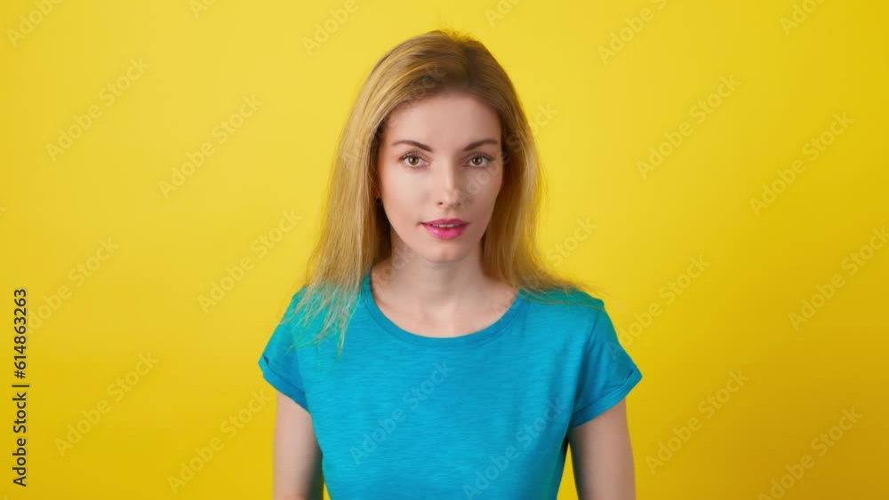 Young woman showing handshake gesture, hello hi, friendly smiling invite. Exited joyful blonde lady greeting and welcoming, wave hand in trendy outfit. Studio shot isolated on yellow background. Young woman showing handshake gesture, hello hi, friendly smiling invite. Exited joyful blonde lady greeting and welcoming, wave hand in trendy outfit. Studio shot isolated on yellow background.