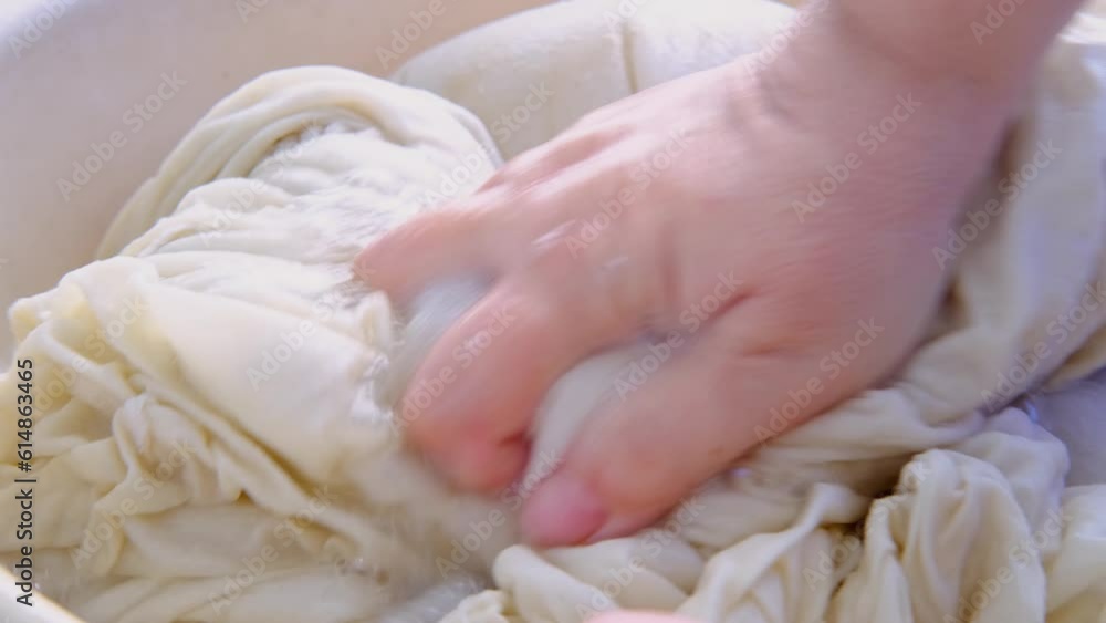 close-up female hands of middle-aged woman wash at home in basin, pre-soak dirty sheets for washing, home chores concept, routine housework, housekeeping, washing machine broke down, selective focus close-up female hands of middle-aged woman wash at home in basin, pre-soak dirty sheets for washing, home chores concept, routine housework, housekeeping, washing machine broke down, selective focus
