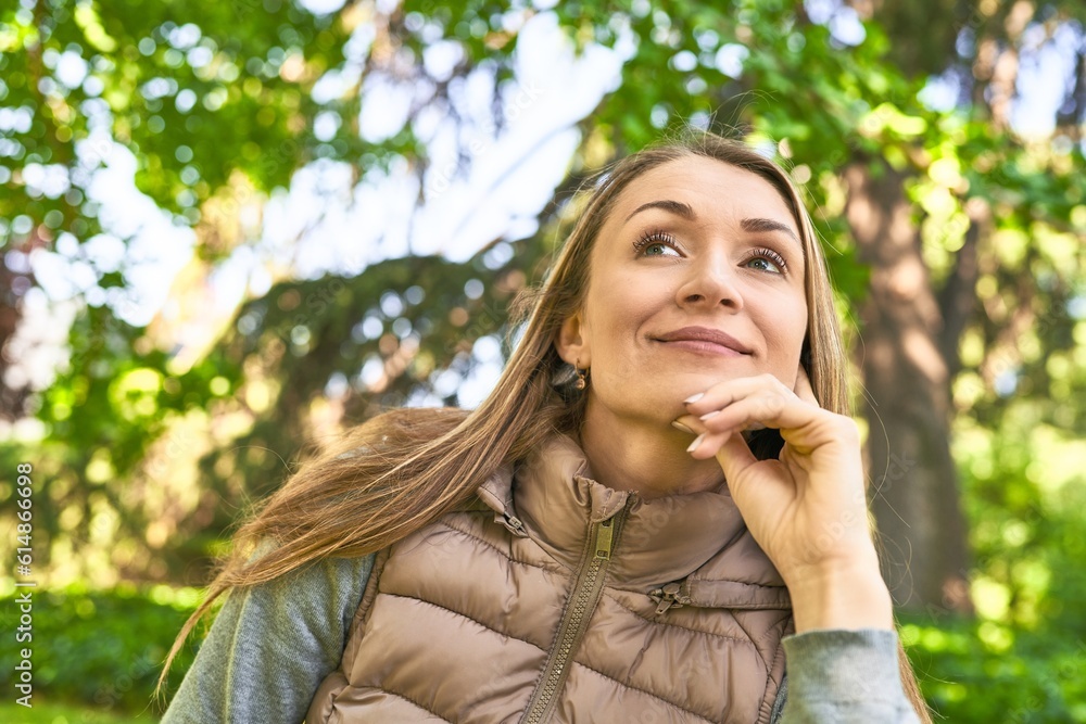 Seizing the day, her smile to the camera radiates joy in the park. Seizing the day, her smile to the camera radiates joy in the park.