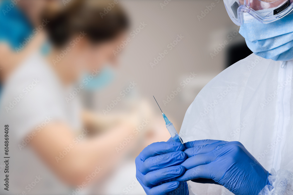 close up of male doctor holding syringe with injection. close up of male doctor holding syringe with injection.