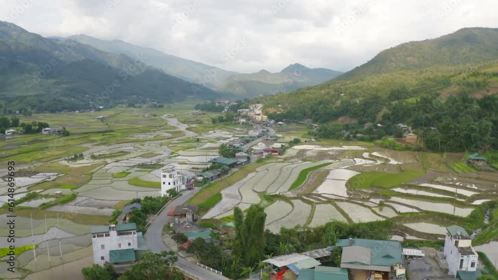Aerial top view of fresh paddy rice terraces, green agricultural fields in countryside or rural area of Mu Cang Chai, mountain hills valley in Asia, Vietnam. Nature landscape background. Aerial top view of fresh paddy rice terraces, green agricultural fields in countryside or rural area of Mu Cang Chai, mountain hills valley in Asia, Vietnam. Nature landscape background.