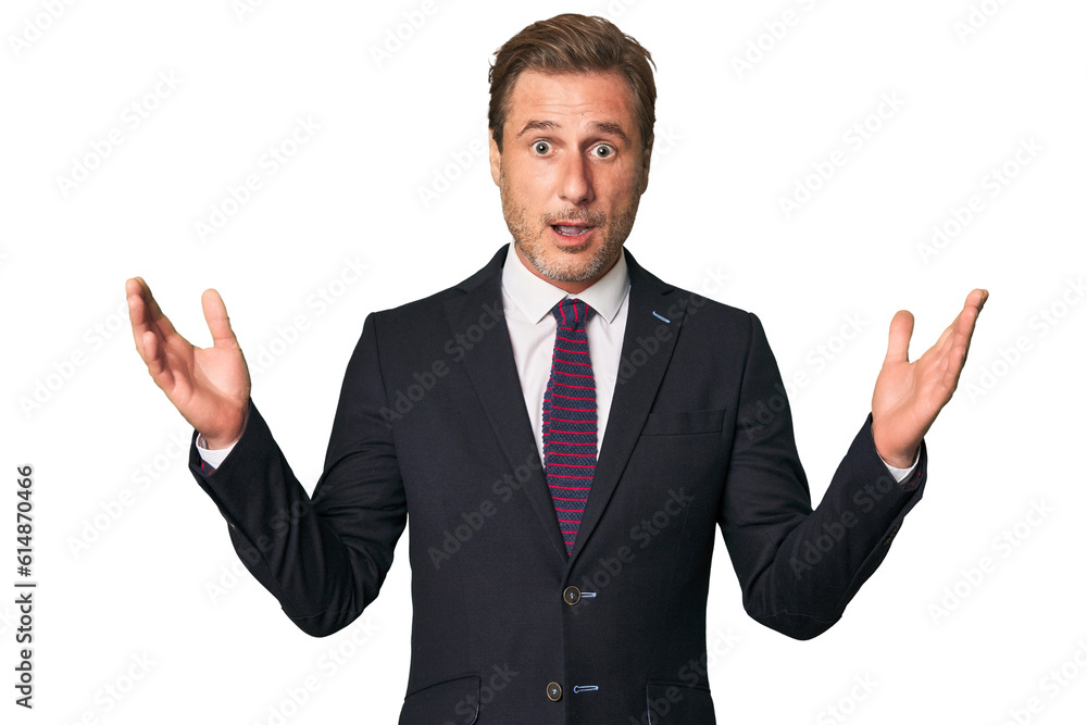 A middle-aged businessman isolated receiving a pleasant surprise, excited and raising hands. A middle-aged businessman isolated receiving a pleasant surprise, excited and raising hands.