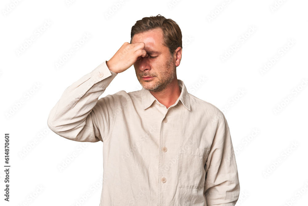A middle-aged man isolated having a head ache, touching front of the face. A middle-aged man isolated having a head ache, touching front of the face.