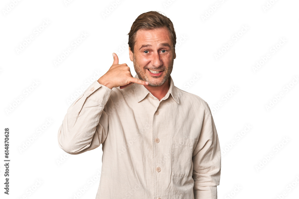 A middle-aged man isolated showing a mobile phone call gesture with fingers. A middle-aged man isolated showing a mobile phone call gesture with fingers.