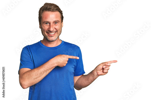 A middle-aged man isolated excited pointing with forefingers away. photo