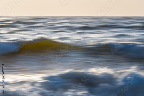 Dramatic seascape abstract. Sea waves in motion blur, and clear sky in the background, fine art. Pacific Ocean, California