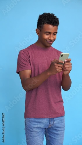 Entertained man watching videos with mobile phone. Vertical video.