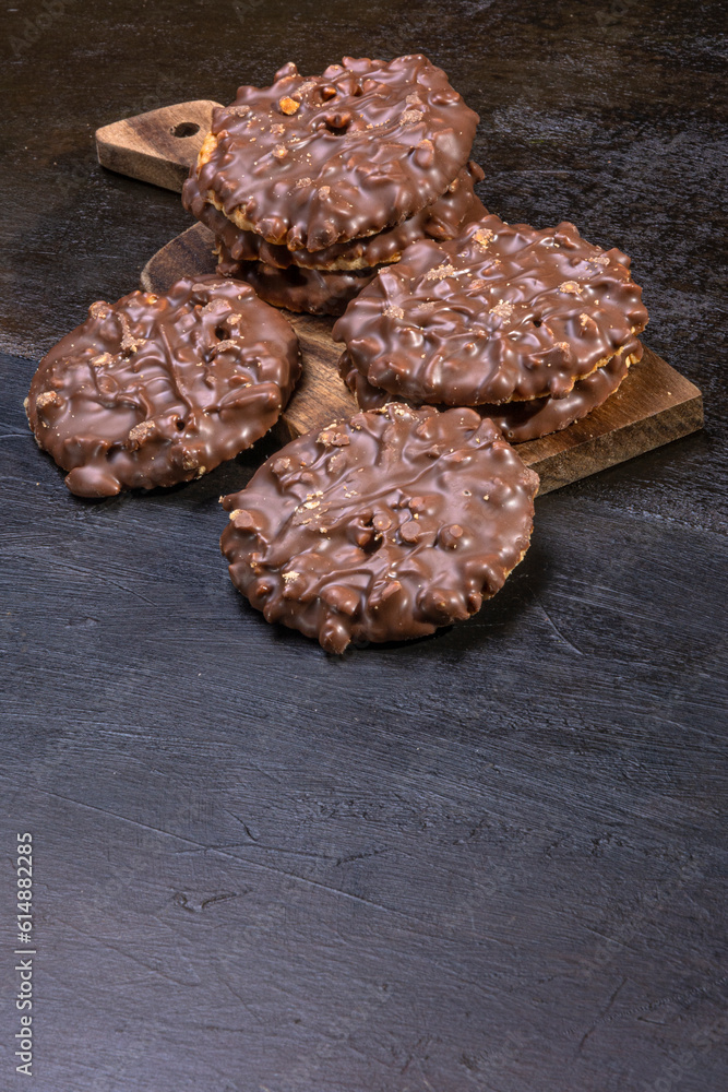 Chocolate and hazelnut coated cookies on a wooden tray Chocolate and hazelnut coated cookies on a wooden tray Chocolate and hazelnut coated cookies on a wooden tray Chocolate and hazelnut coated cookies on a wooden tray Chocolate and hazelnut coated cookies on a wooden tray Chocolate and hazelnut coated cookies on a wooden tray
