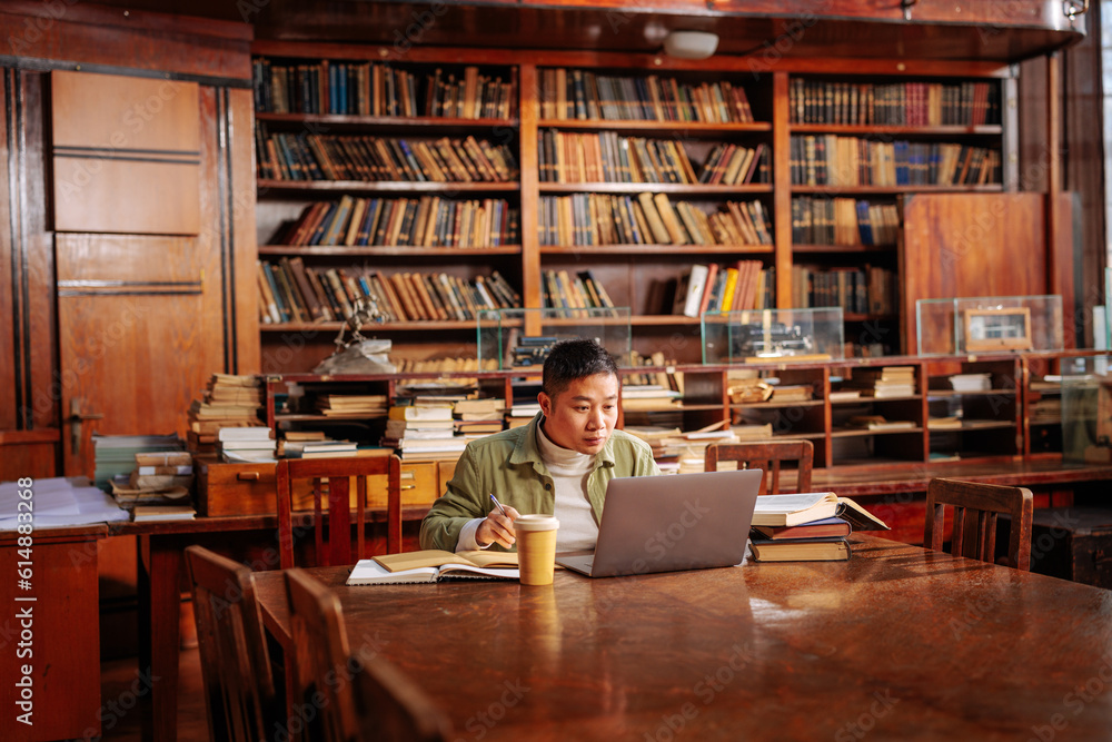 Student doing research in library. Student doing research in library.