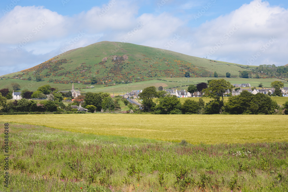 Rolling hills countryside landscape and a golden summer field in the Scottish village of Upper Largo seen from Lower Largo in Fife, Scotland, UK. Rolling hills countryside landscape and a golden summer field in the Scottish village of Upper Largo seen from Lower Largo in Fife, Scotland, UK.