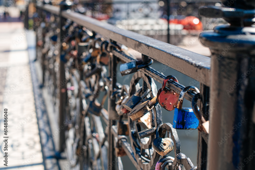 Fototapeta premium Padlocks on the bridge. Symbol of love, trust and family. The tradition of hanging a padlock on the wedding day.