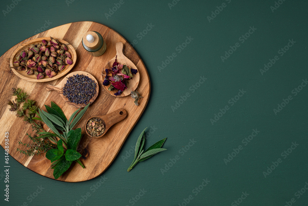 Botanical blends, herbs, essencial oils for naturopathy. Natural remedy, herbal medicine, blends for bath and tea on wooden table background - obrazy, fototapety, plakaty 
