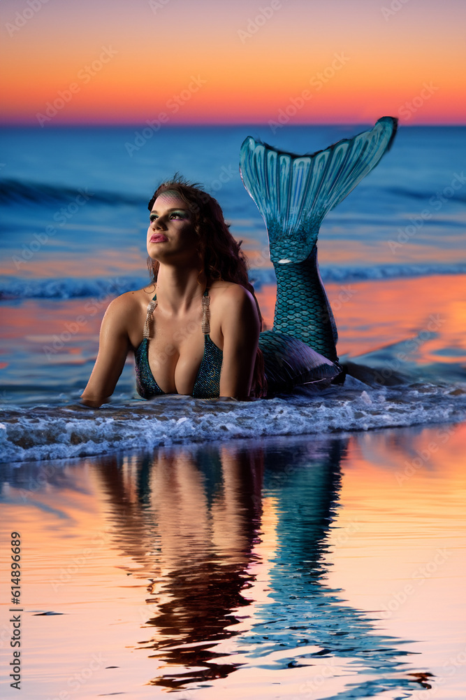 mermaid in blue top on a beach
