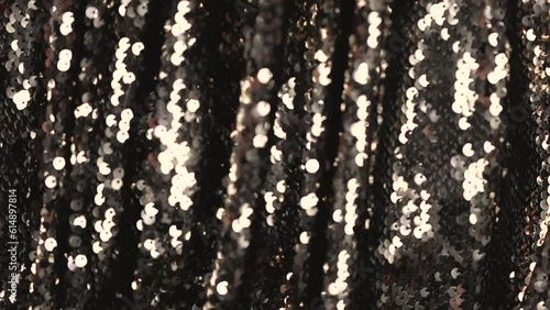 abstract beautiful festive shiny background with golden sparkles and bokeh. Fabric with sequins